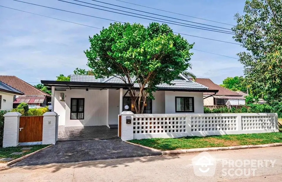 Charming single-story house with modern design and lush greenery in a serene neighborhood.