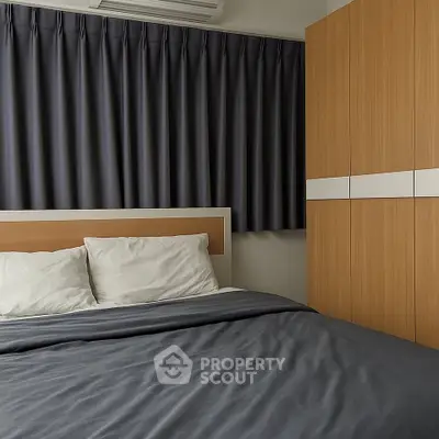 Modern bedroom with sleek design, featuring a comfortable bed and stylish wardrobe.