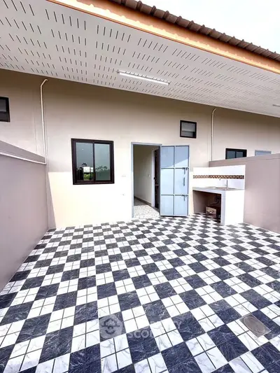 Modern outdoor patio with checkered tile flooring and sleek exterior design