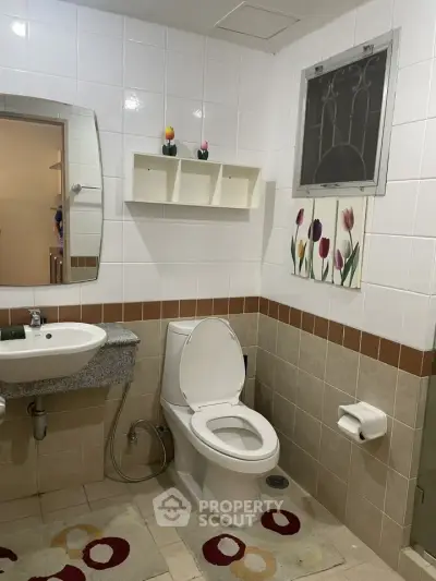 Charming bathroom with modern fixtures and decorative accents in a cozy home setting.