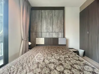 Modern bedroom with stylish wood paneling and large window for natural light.