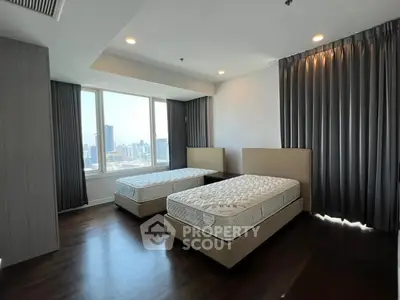 Spacious bedroom with twin beds and city view in modern apartment