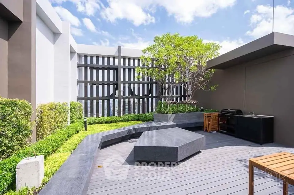 Modern rooftop terrace with stylish seating and lush greenery, perfect for relaxation and entertainment.