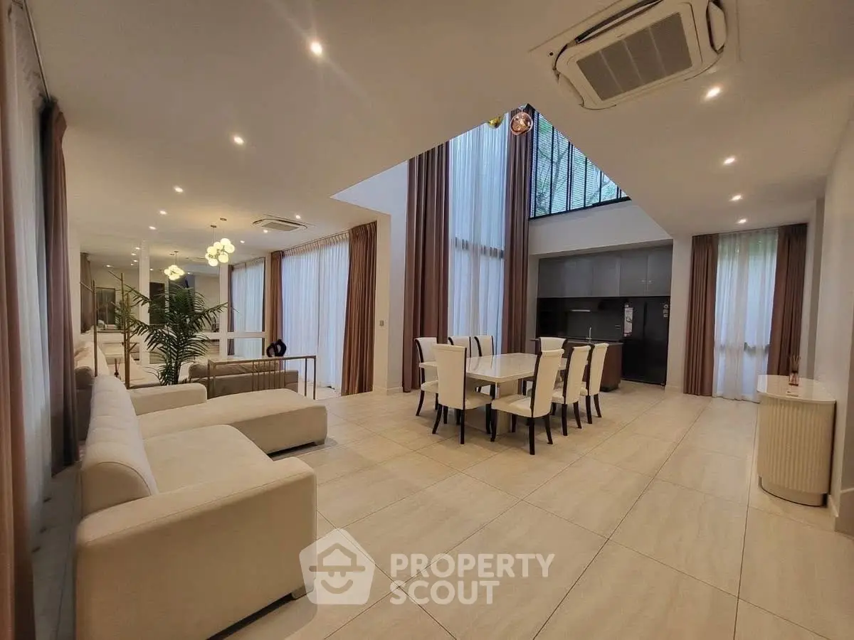 Spacious modern living and dining area with high ceilings and elegant decor