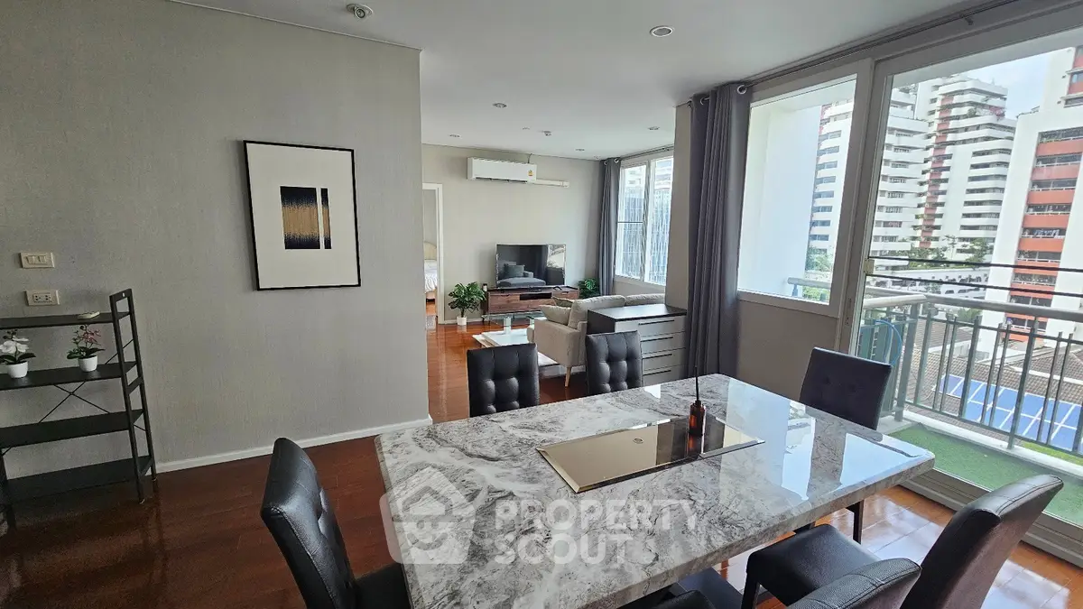 Spacious modern living and dining area with balcony view in urban apartment