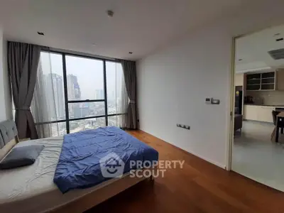 Spacious bedroom with city view and modern kitchen in luxury apartment