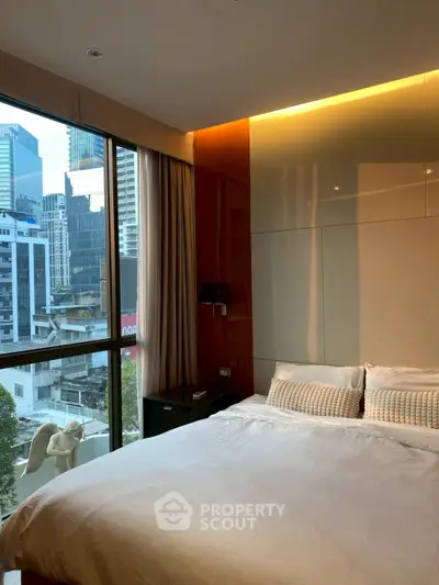 Luxurious bedroom with city view and modern decor in high-rise apartment