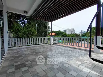 Spacious balcony with tiled flooring and scenic view, perfect for relaxation and outdoor gatherings.