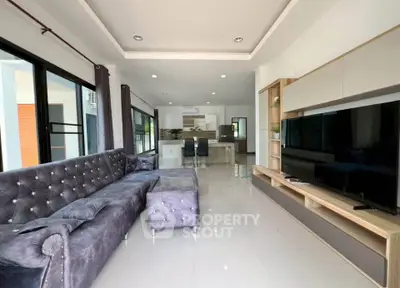 Spacious modern living room with plush sectional sofa and sleek entertainment center.