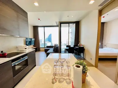 Modern open-layout kitchen and living room with city view in luxury apartment