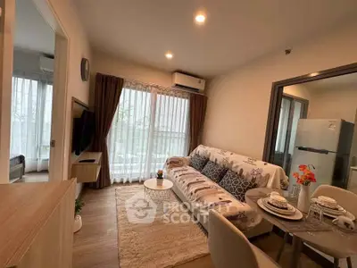 Modern living room with cozy decor and natural light, featuring a stylish sofa and dining area.