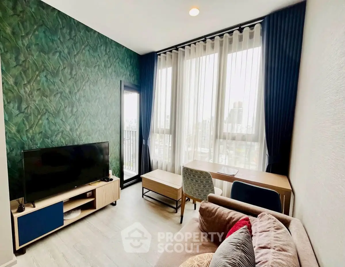 Modern living room with stylish decor, large windows, and city view, perfect for urban living.