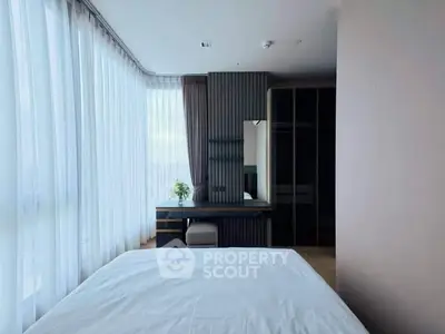Modern bedroom with large windows and stylish decor, perfect for natural light lovers.