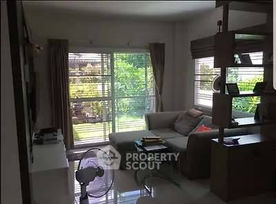 Cozy living room with garden view and modern furnishings