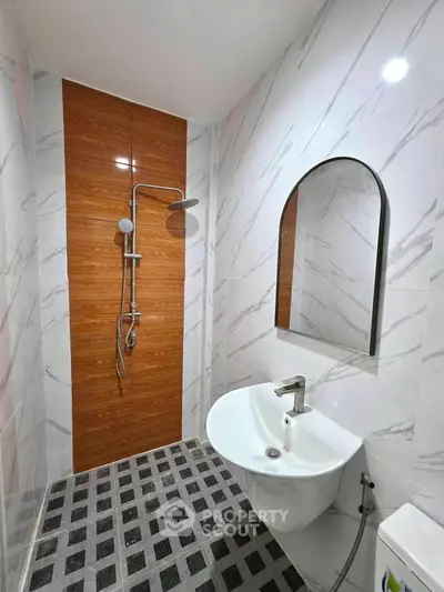 Modern bathroom with sleek shower and stylish sink in a contemporary design.