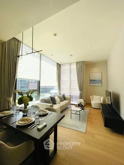Elegant living room with modern decor and large windows offering natural light