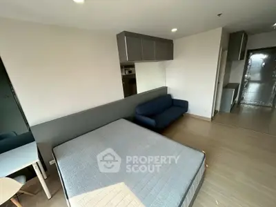 Modern studio apartment with cozy living area and sleek furnishings, perfect for urban living.