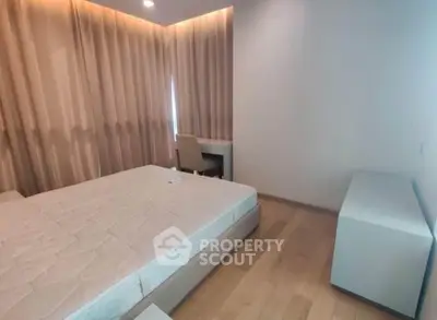 Spacious bedroom with modern furnishings and natural light