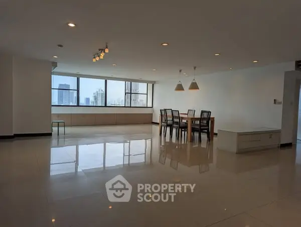 Spacious modern dining area with city view and ample natural light.
