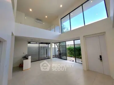 Spacious modern living room with high ceilings and large windows