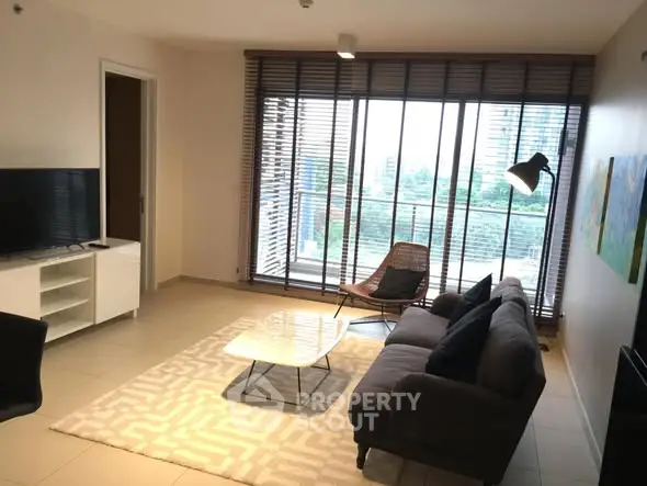 Spacious living room with modern decor and large windows offering a scenic view.