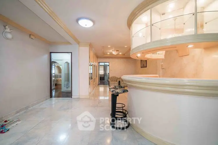 Spacious modern living area with elegant marble flooring and stylish bar counter