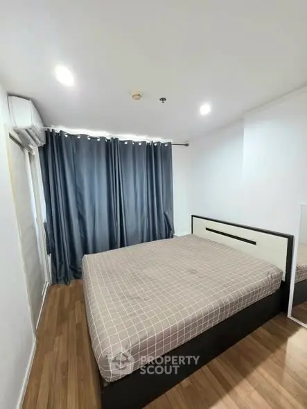 Spacious bedroom with modern decor and ample natural light