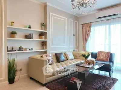 Elegant living room with plush sofa, chic decor, and natural light from large windows.