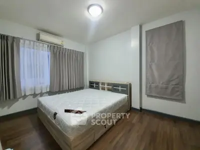 Spacious bedroom with modern decor and natural light