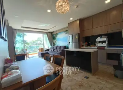 Spacious open-layout kitchen and living room with modern decor and natural light.