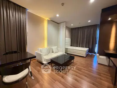Luxurious studio apartment with modern furnishings and elegant wooden flooring.