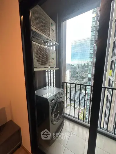 Modern high-rise balcony with city view and washing machine setup.