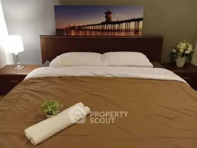 Cozy bedroom with elegant decor and soft lighting, featuring a comfortable bed and stylish artwork.