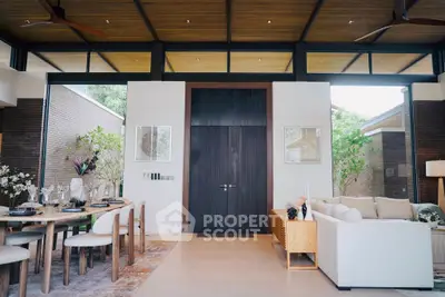 Luxurious modern living room with high ceilings, elegant dining area, and stylish decor.