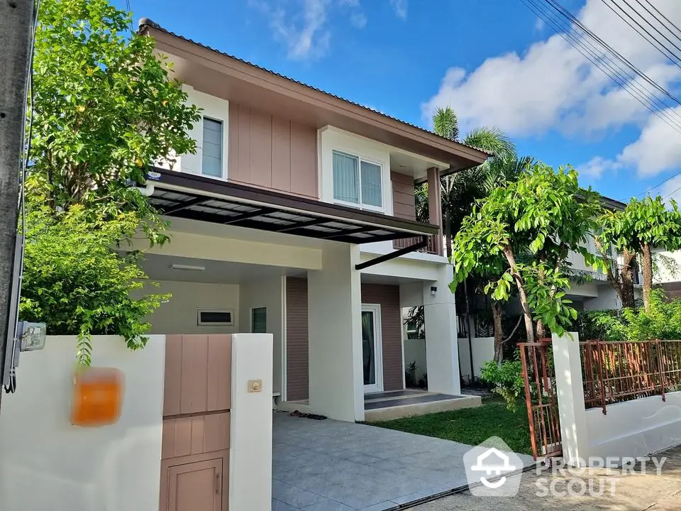 Charming two-story house with lush greenery and modern design in a serene neighborhood.