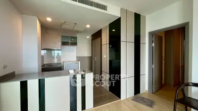 Modern kitchen with sleek cabinetry and open layout in a stylish apartment