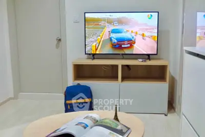 Modern living room with sleek TV setup and stylish furniture, perfect for relaxation and entertainment.