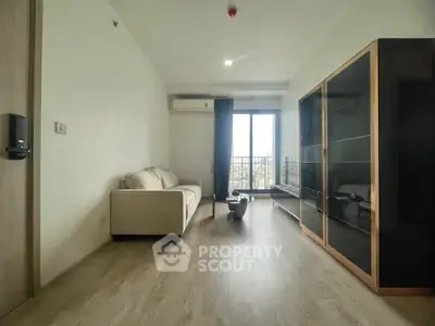 Modern living room with sleek furniture and balcony view in a stylish apartment.