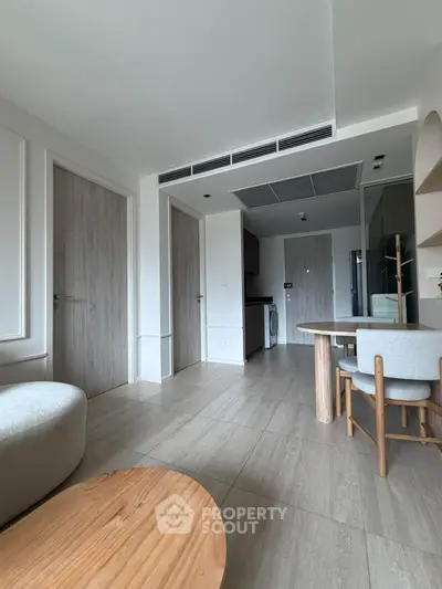 Modern apartment interior with stylish furniture and open layout, featuring a cozy living area and sleek kitchen.