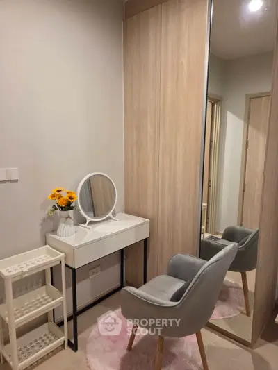 Chic and cozy bedroom corner with stylish vanity and plush chair