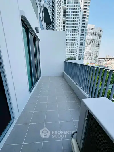 Spacious balcony with city view in modern high-rise apartment