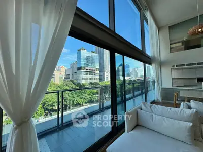 Luxurious high-rise apartment with stunning city view and spacious balcony.