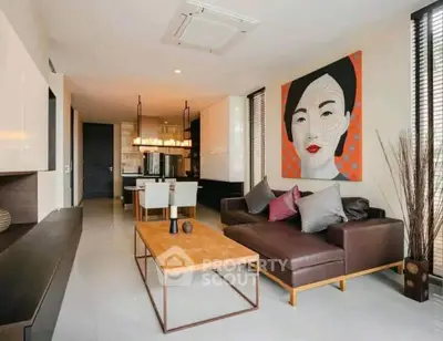 Modern living room with stylish decor and open dining area, featuring contemporary art and sleek furniture.