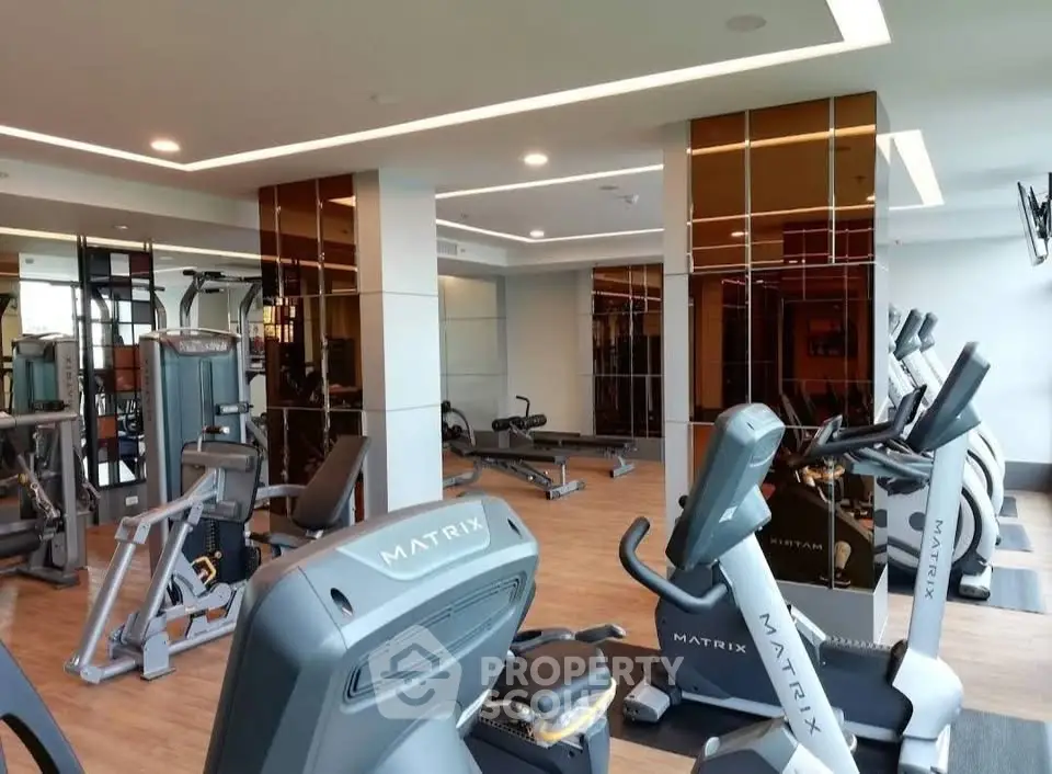 Modern gym with state-of-the-art fitness equipment in a luxury residential building.