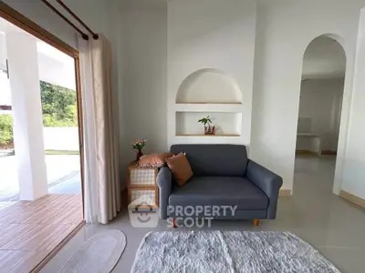 Charming living room with cozy sofa and natural light, perfect for relaxation and comfort.