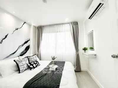Modern bedroom with stylish decor and natural light, featuring a cozy bed and elegant curtains.