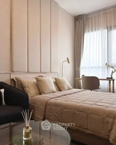 Luxurious bedroom with elegant decor and natural light, featuring a cozy bed and stylish furnishings.