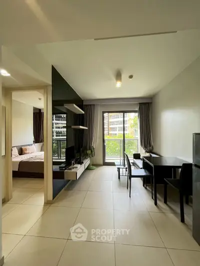 Modern open-plan living room with balcony view in a stylish apartment