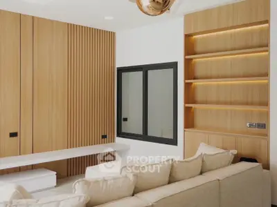 Modern living room with beige sofa, wooden paneling, and built-in shelves