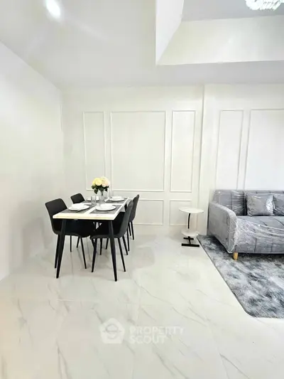 Modern living room with elegant dining area and sleek furniture